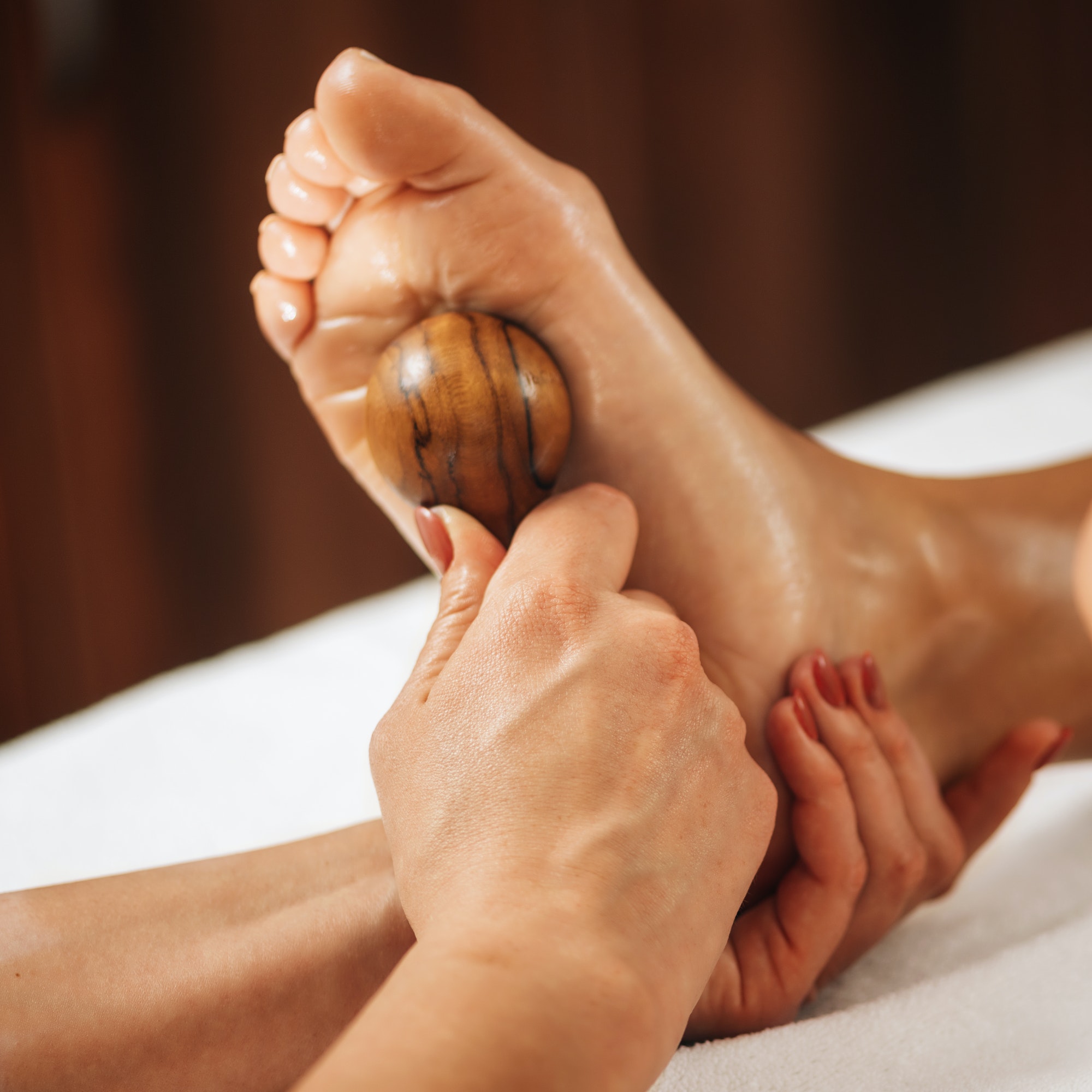 Reflexology - Foot Massage with Wooden Massage Tool.