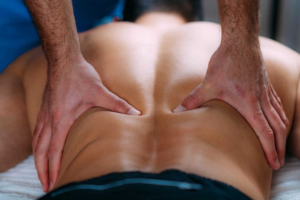 Discus Hernia Manual Massage Treatment. Physical Therapist Massaging Lower Back.